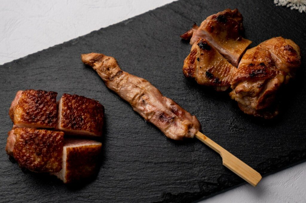 A plate of "Duck 3 Ways" at The Orchid Duck, a Japanese restaurant in Ubud. The dish features three different preparations of duck